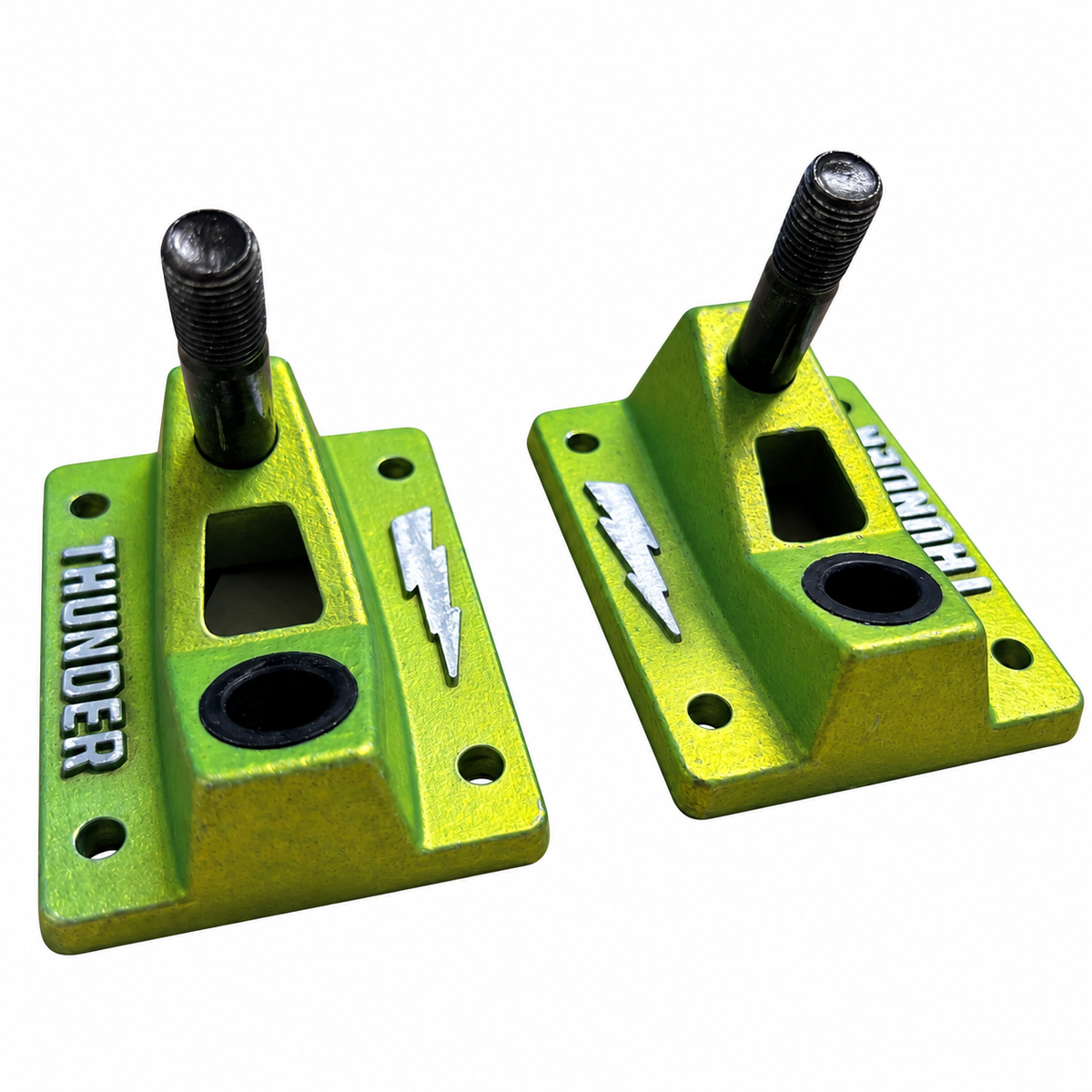Pair of metallic green Thunder skateboard truck baseplates with kingpins and pivot cups